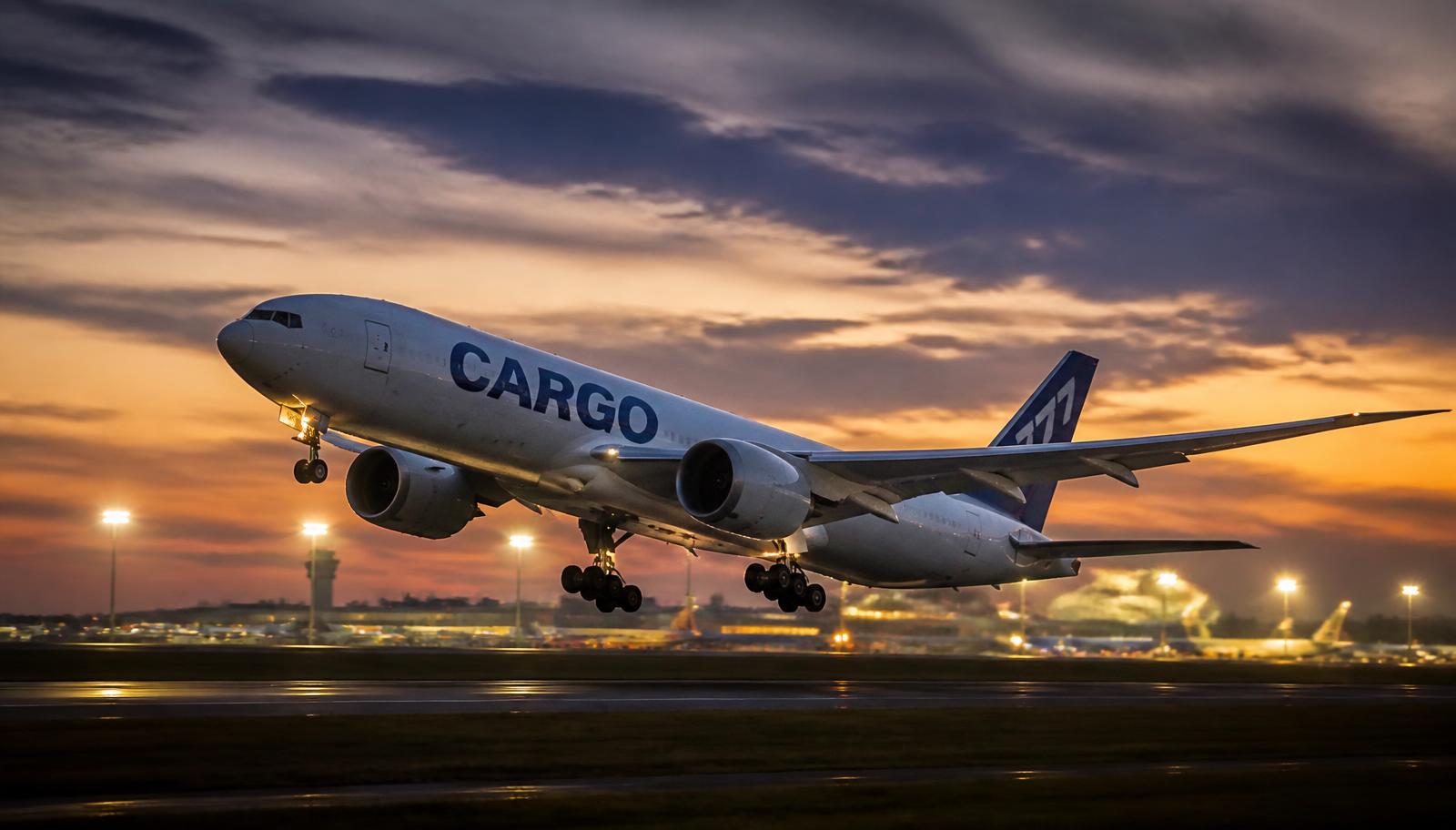 Cargo freighter aircraft departing at dusk